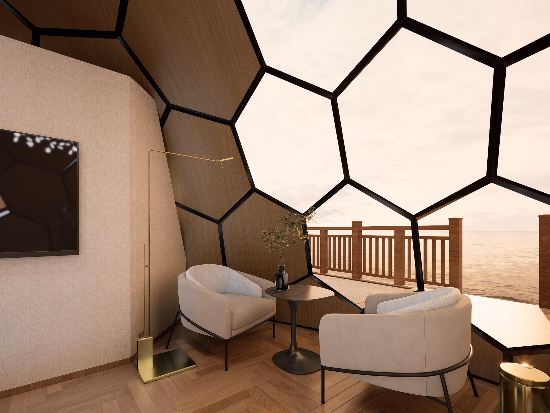 Twin armchairs and a small side table beside the dome's glass wall, calm Caribbean water through the panels