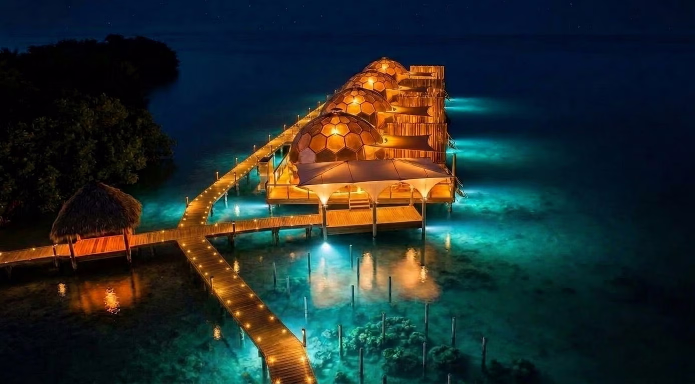 Overwater resort domes glowing at night on private island, Bocas del Toro